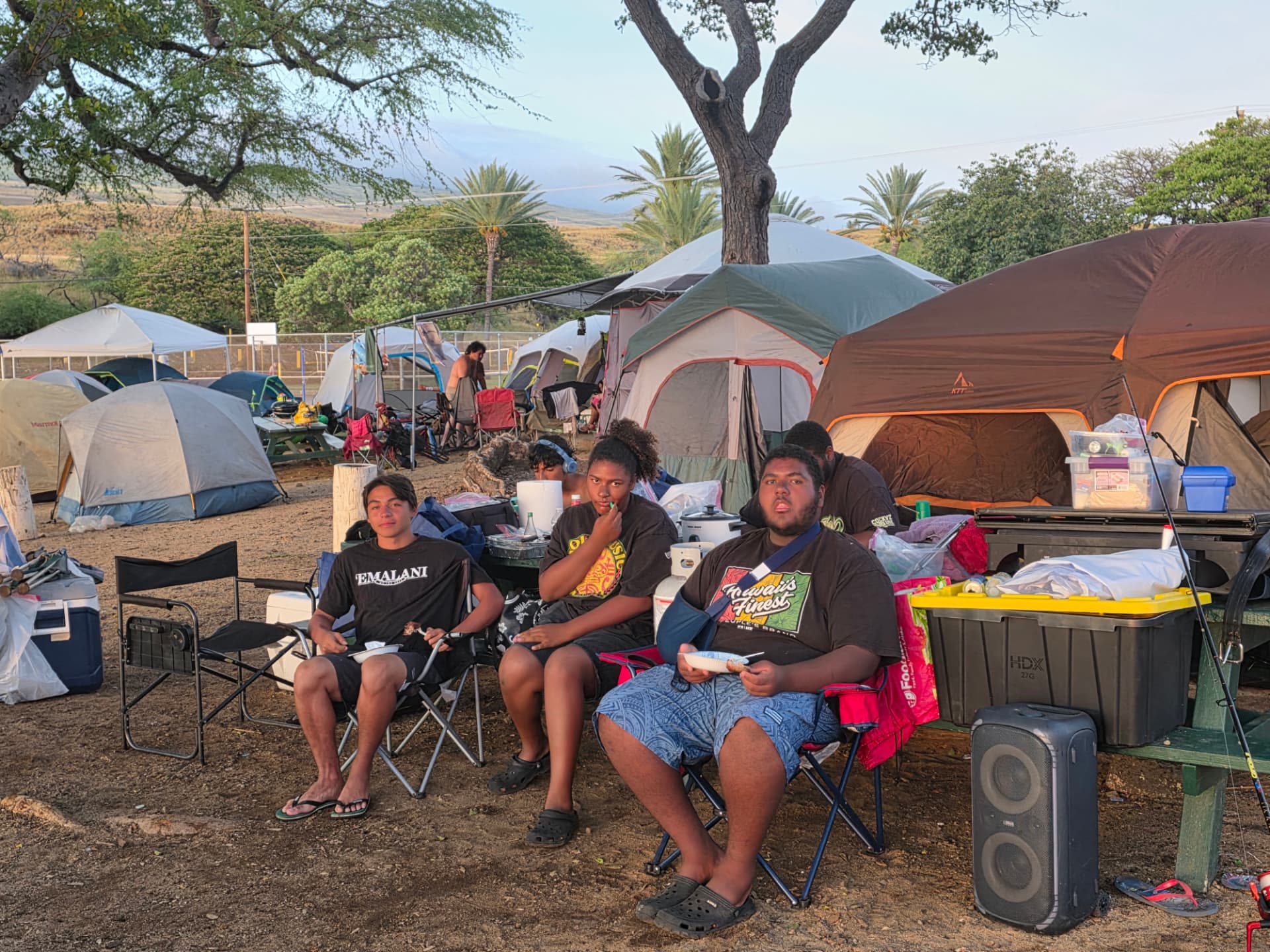 Youth eating a hot meal together at the Hawaiʻi Island camp site